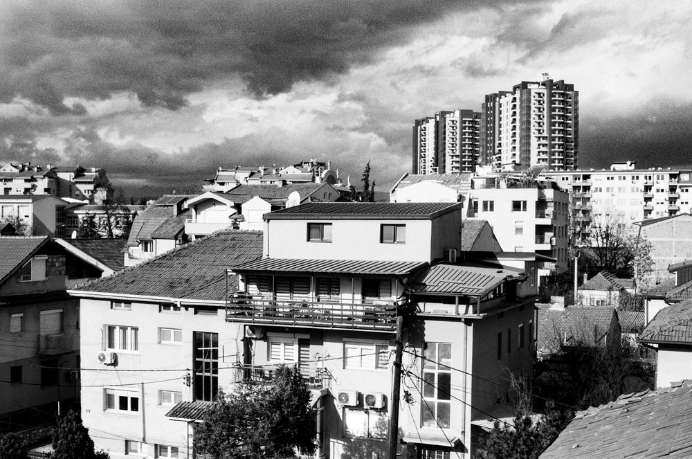 Old buildings from the 60s in the foreground with modern building in the background, Skopje, North Macedonia.
