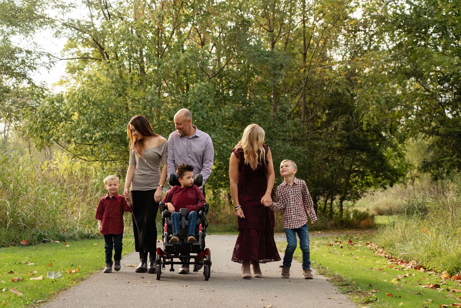 family enjoys walk along paved path