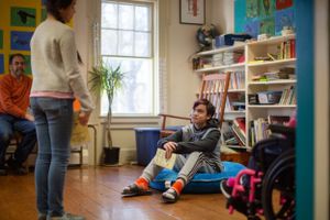 Bright classroom interior with windows, bookshelves, and educational materials on display.