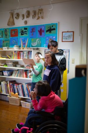 Educational space with student artwork displayed above bookshelves filled with reading materials.