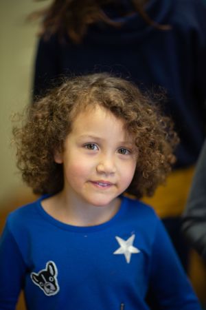 A child wearing a blue shirt with a star design.