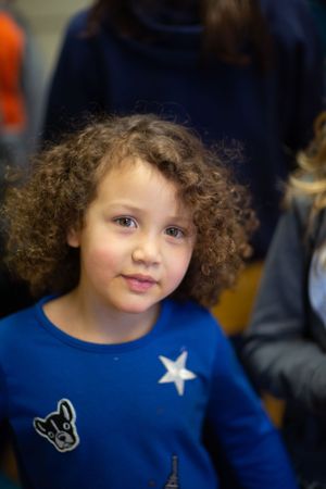 A child wearing a blue shirt with a star design.