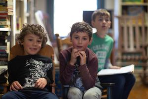 Children participating in an animated classroom discussion.