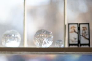 Blurred glass or plastic containers on display shelves creating an abstract pattern.