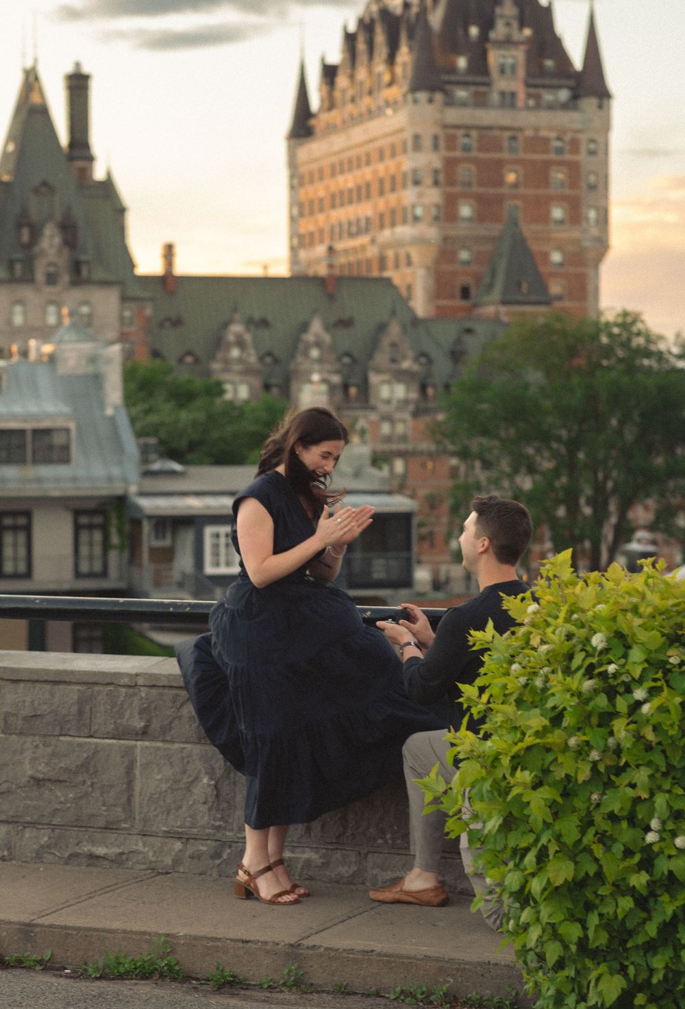 Romantic marriage proposal at dusk with Chateau Frontenac in Quebec City as a stunning backdrop.