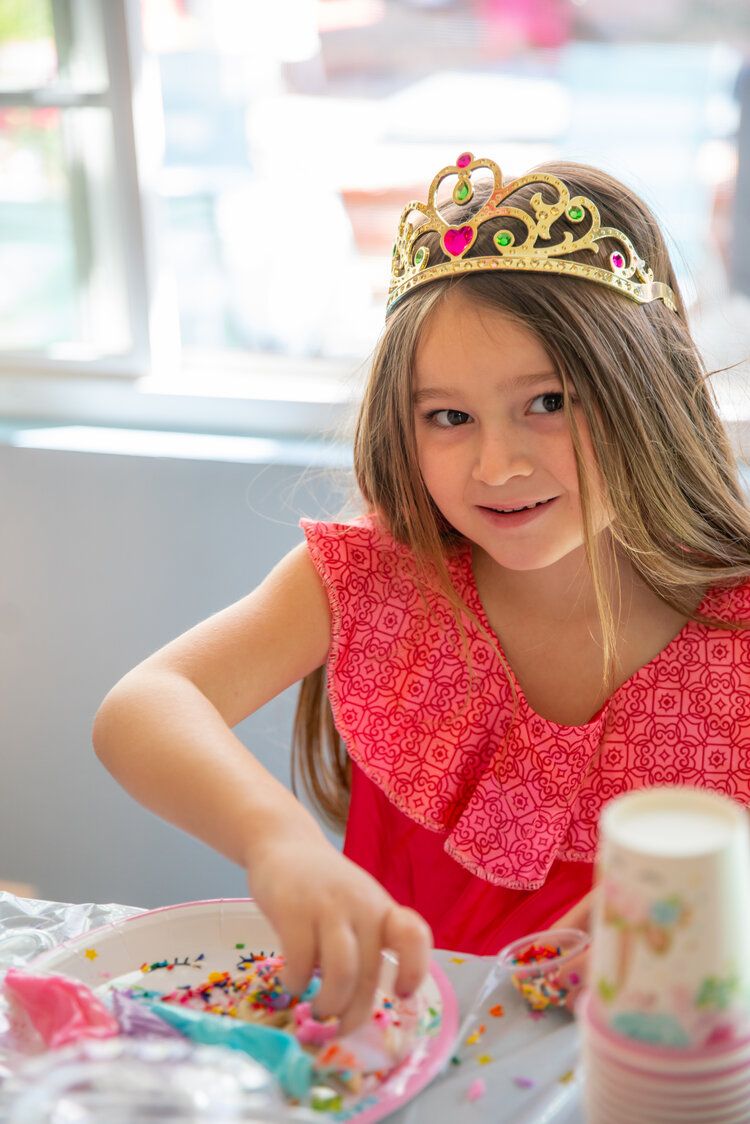 Birthday girl in crown look at the camera