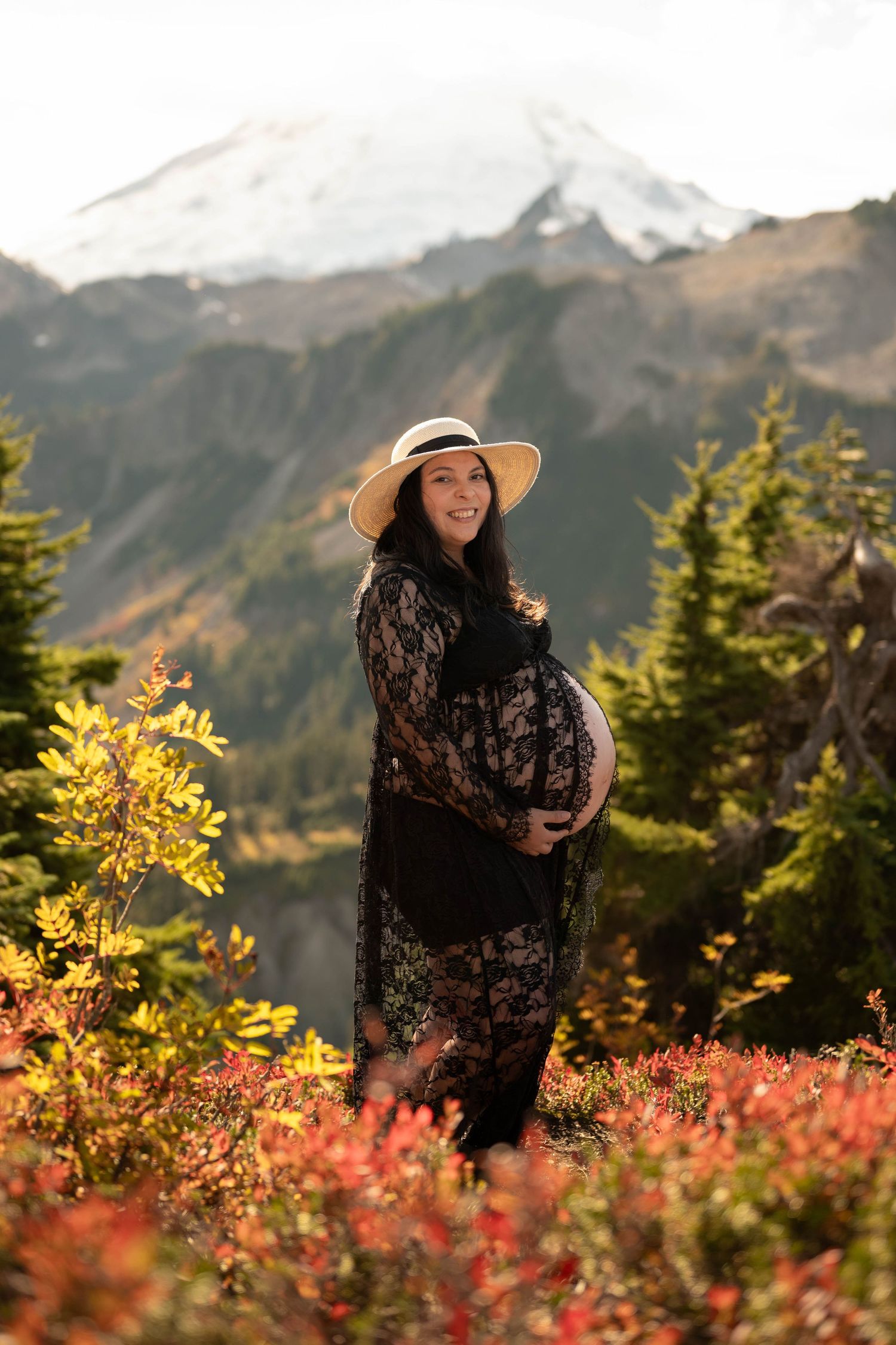 A maternity photo session in the PNW mountains with fall foliage in Washington State.