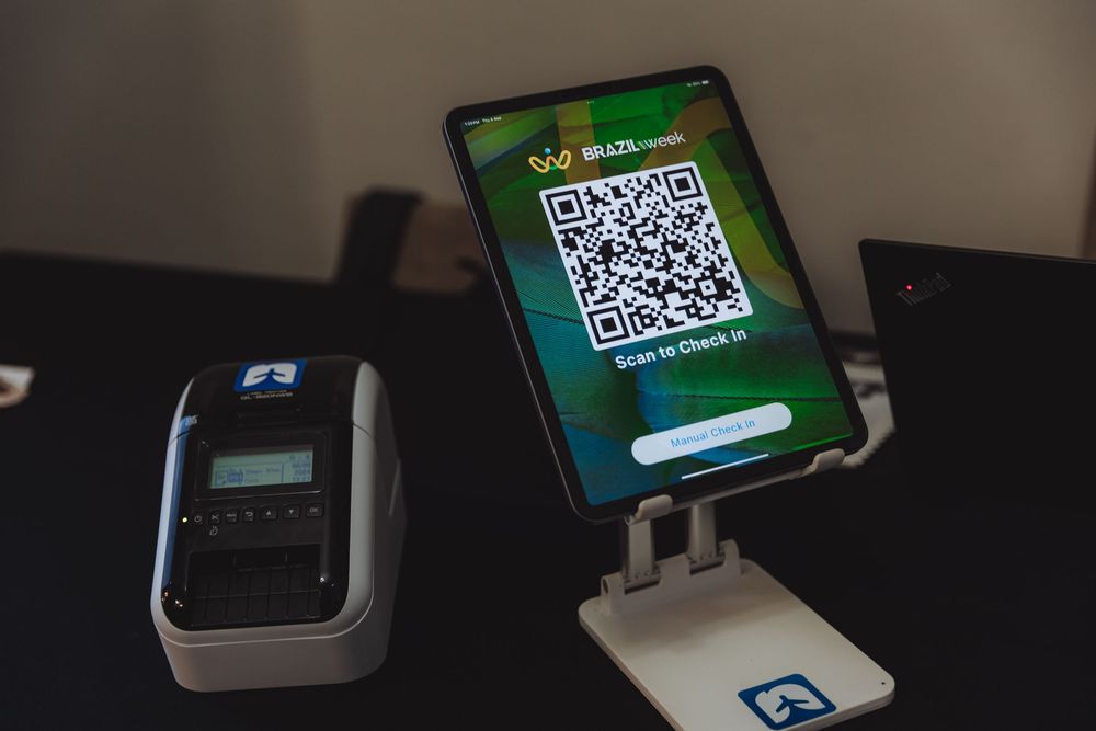 Several digital payment terminals and QR code displays arranged in a row showing modern point-of-sale technology.