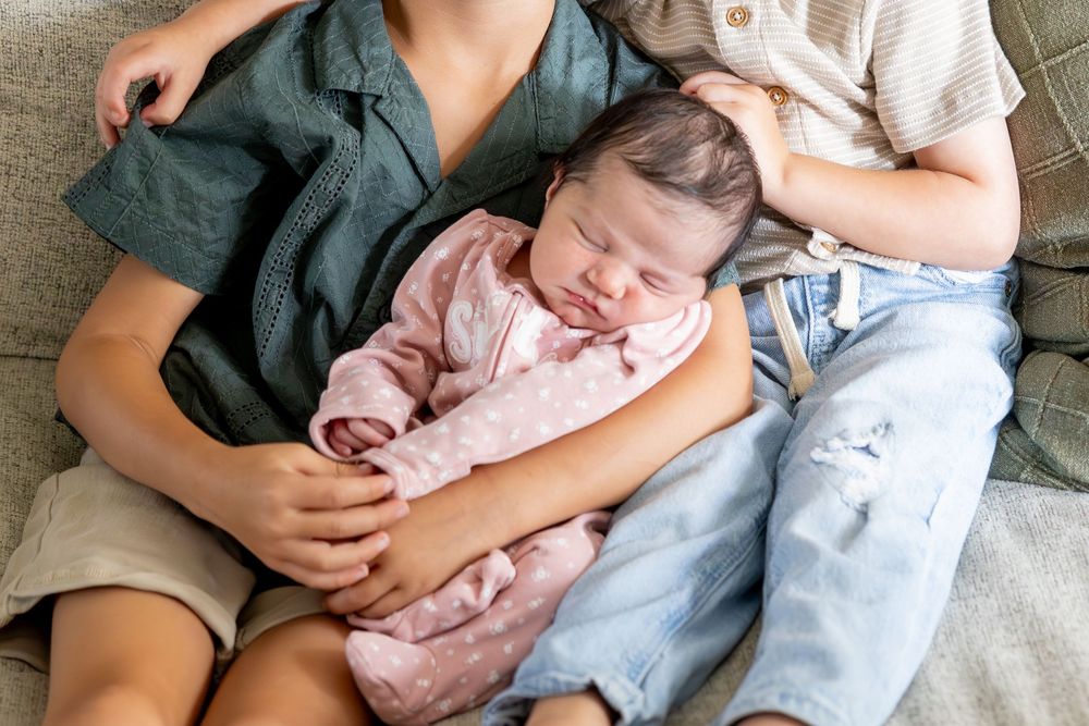 A collection of intimate moments showing a baby being cradled while resting on a couch.