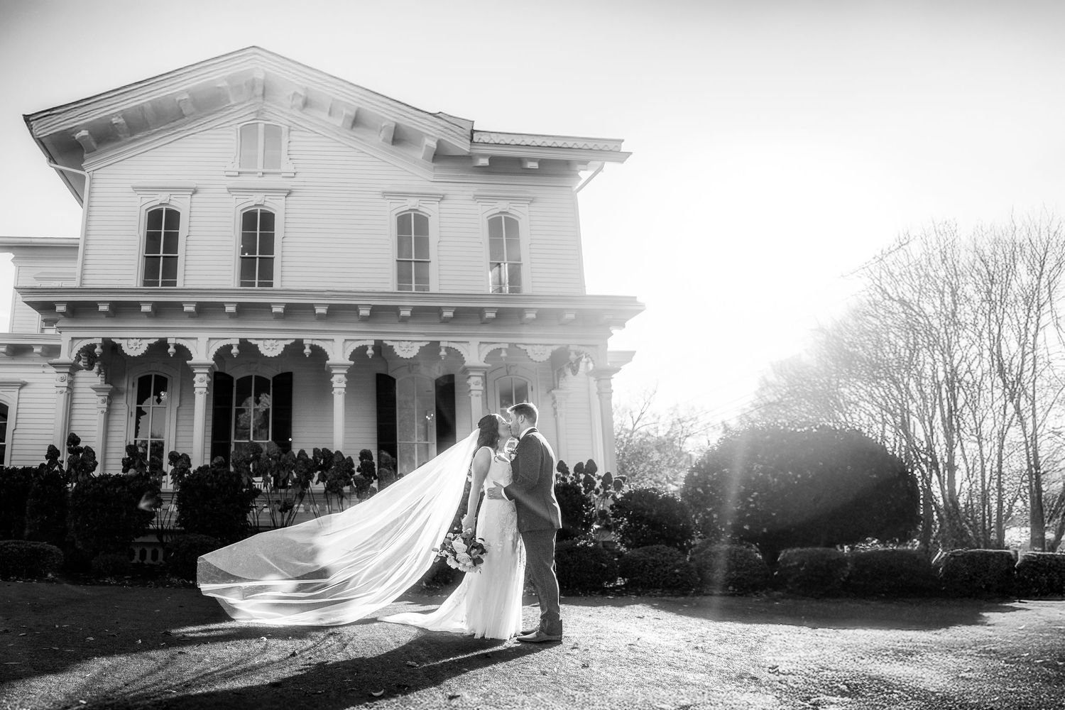 Black and White wedding portrait with dramatic sun flare in Boston