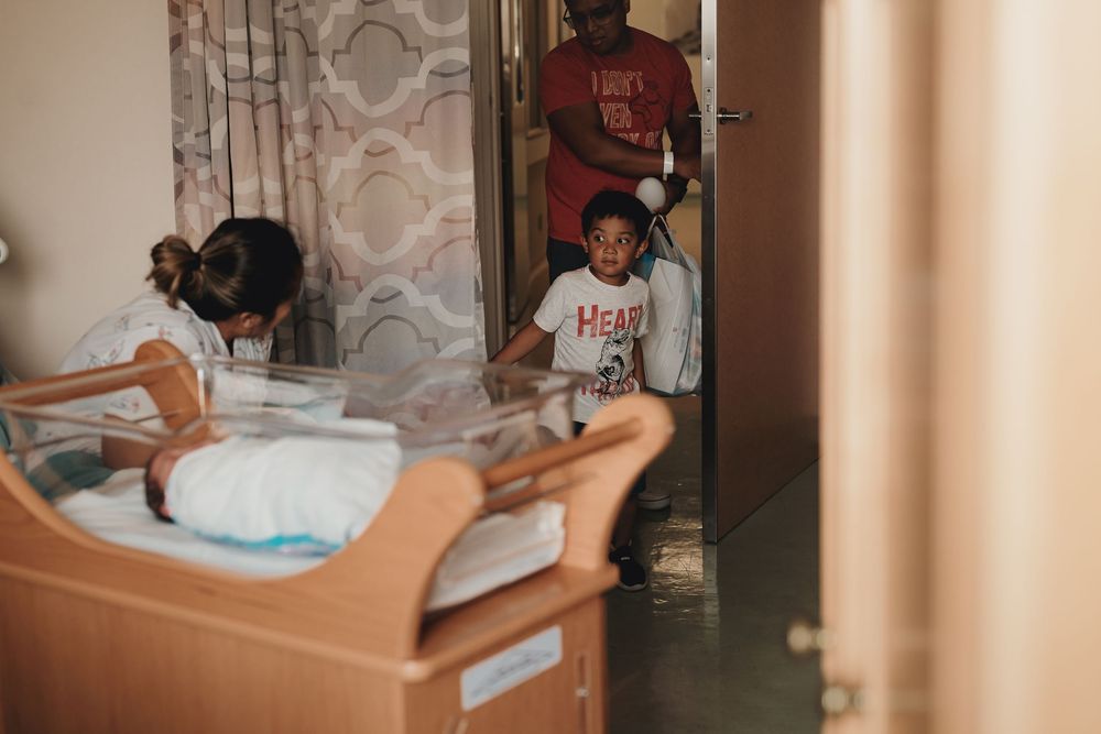 Five sequential photos showing the progressive process of changing a baby's diaper on a changing table.
