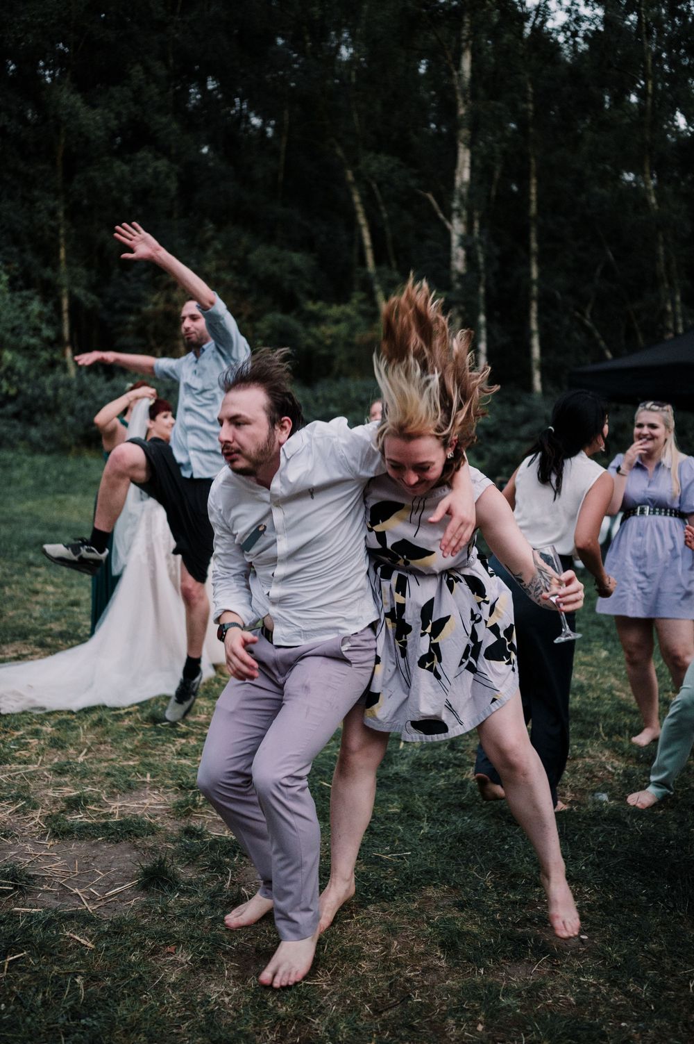 A group shows joyful movement while dancing together outdoors in a candid photo sequence.