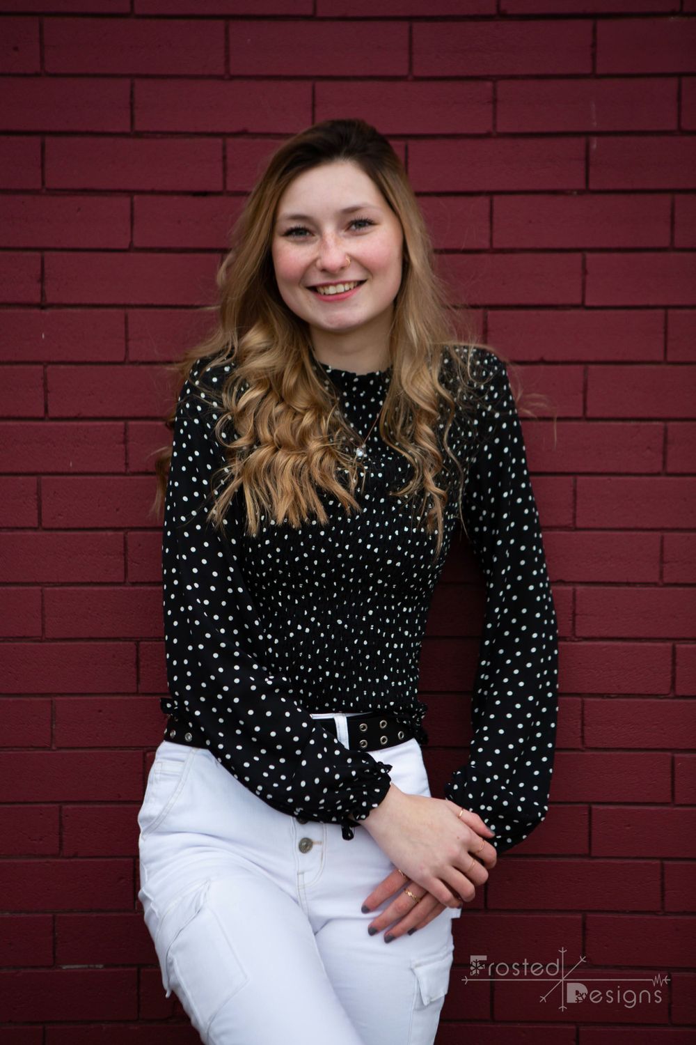 Female girl high school senior photography red brick background with black and white outfit.
