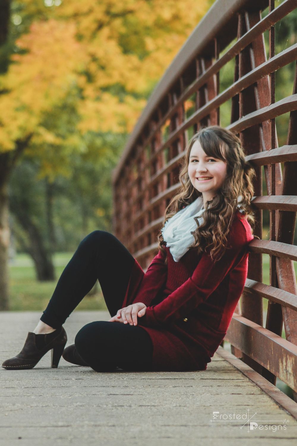 Female girl high school senior photography on park bridge.