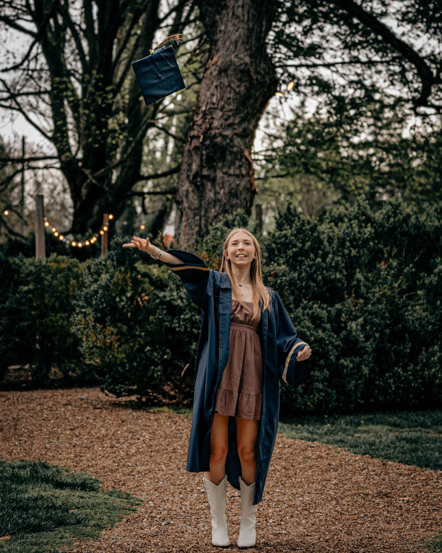A sequential series of outdoor photos showing someone walking in a wooded area wearing a navy blazer and jeans.
