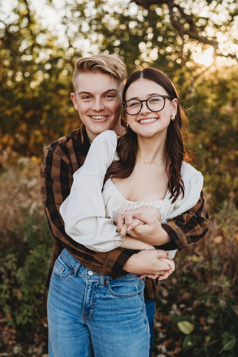 A warm embrace captured during a fall photoshoot with natural lighting.