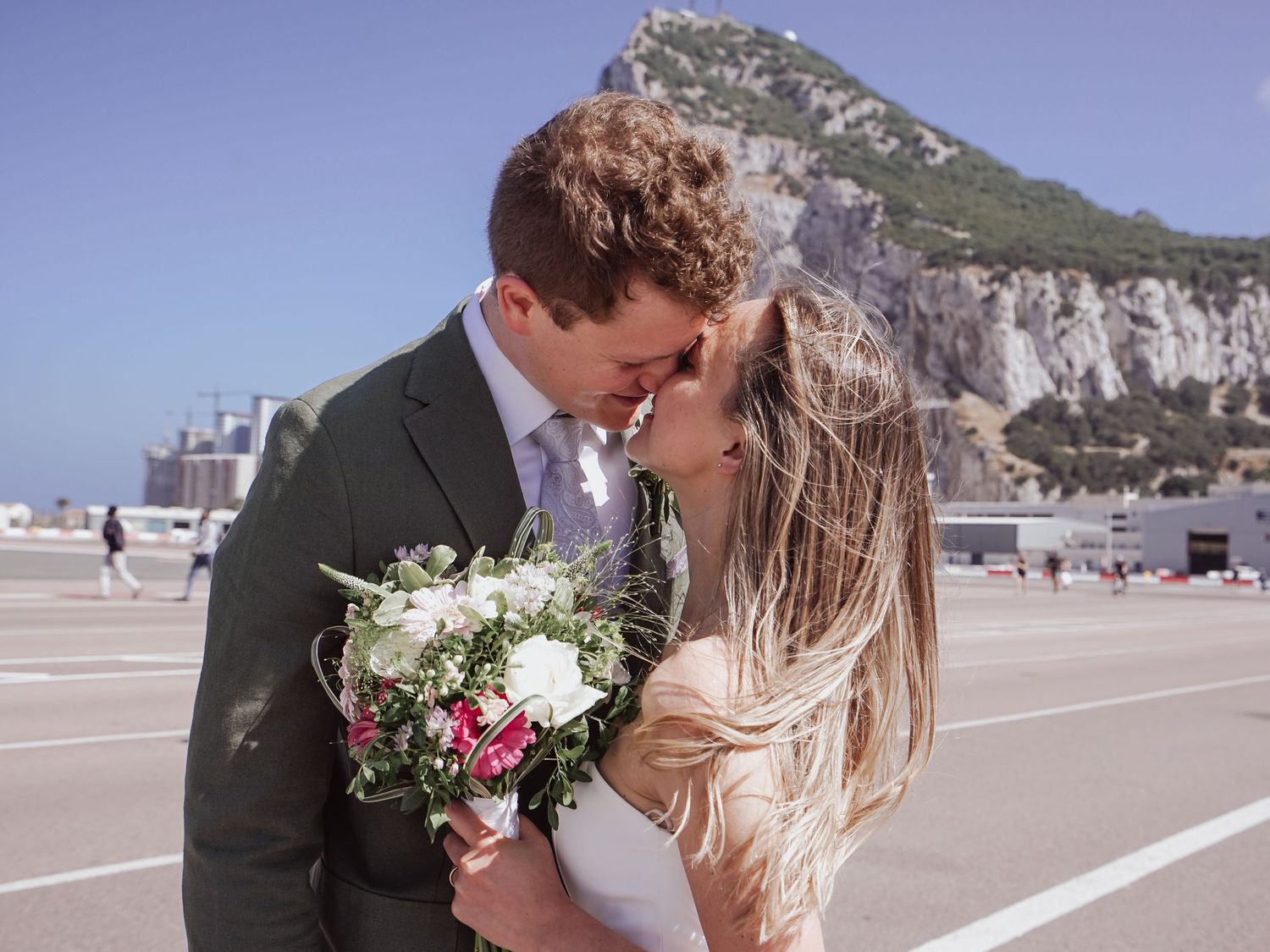 Gibraltar Wedding Couple embrace rock of gibraltar runway