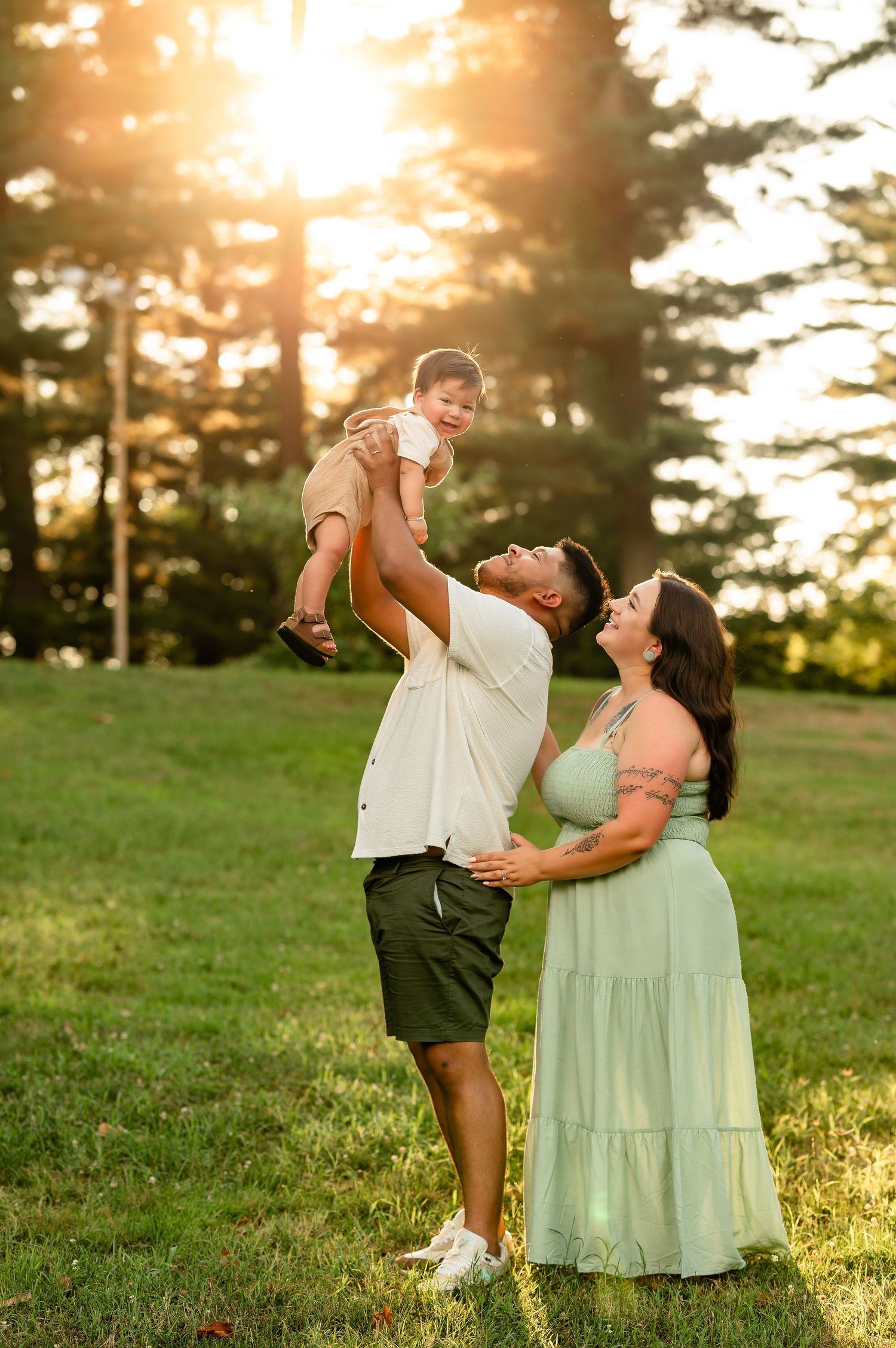 parents lifting toddler during golden hour created by Storms Photography Pennsylvania photographer