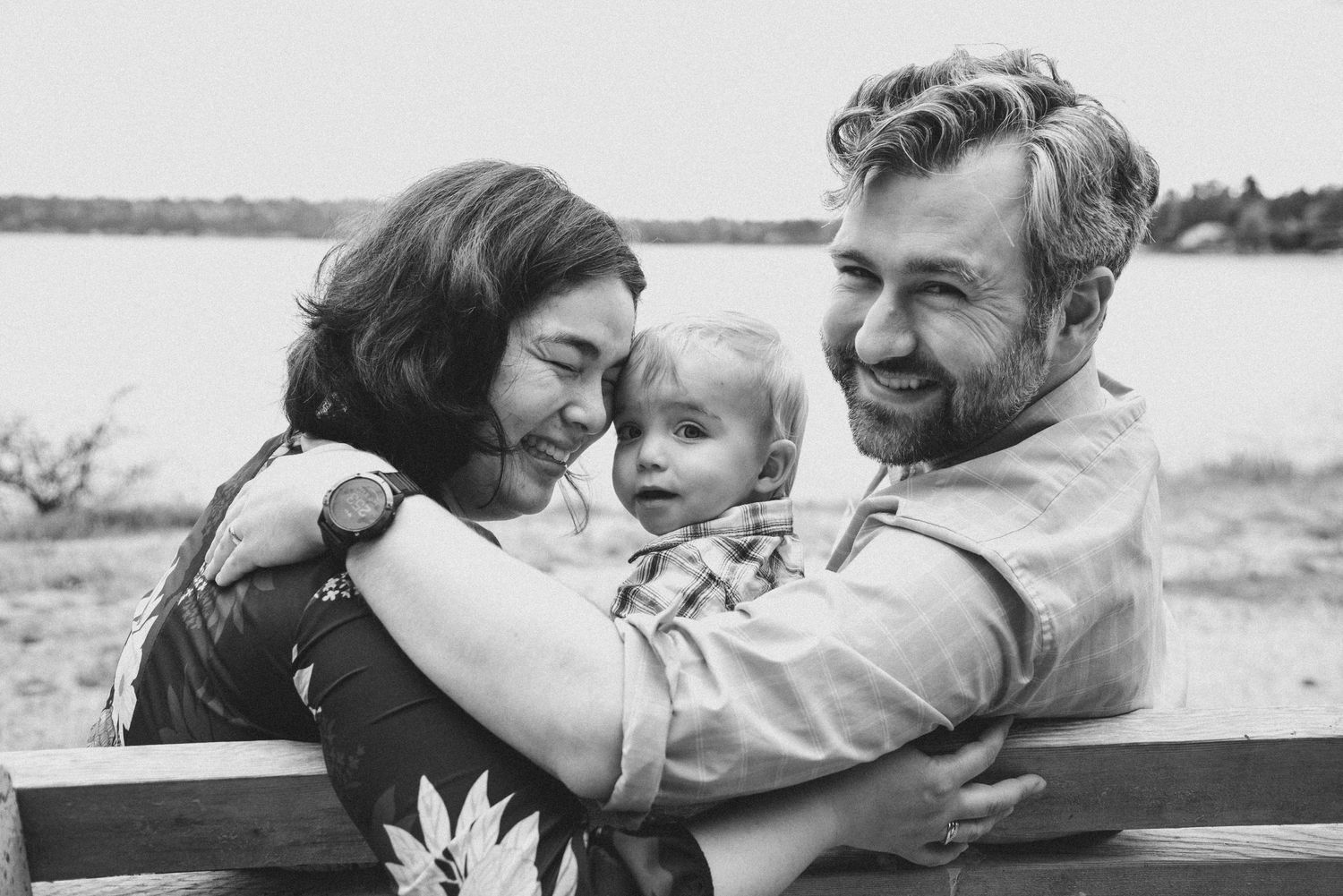 A series of black and white photos showing tender family moments at the beach and outdoors.