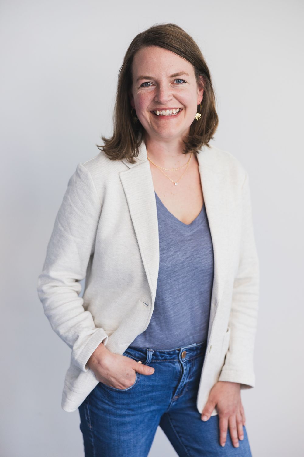maple valley acupuncture, WA woman owner standing for headshot smiling at camera standing in front of white backdrop