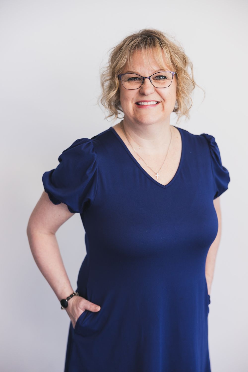 maple valley acupuncture woman owner standing for headshot smiling at camera standing in front of white backdrop