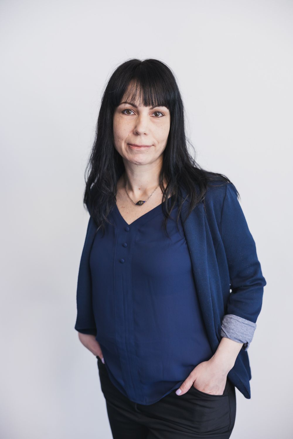 maple valley acupuncture woman owner standing for headshot smiling at camera standing in front of white backdrop