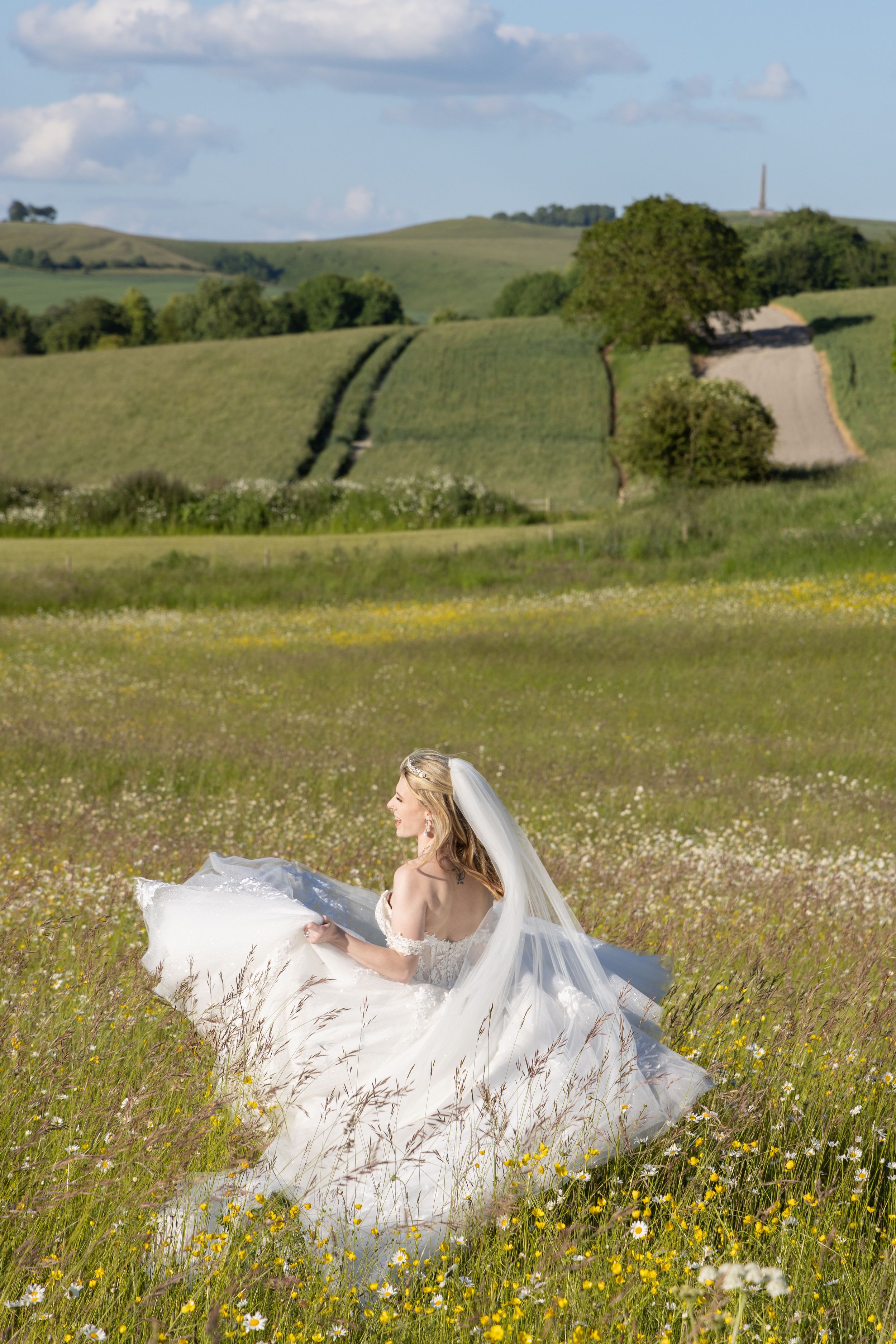 Bride in a flower field at Wellington Barn