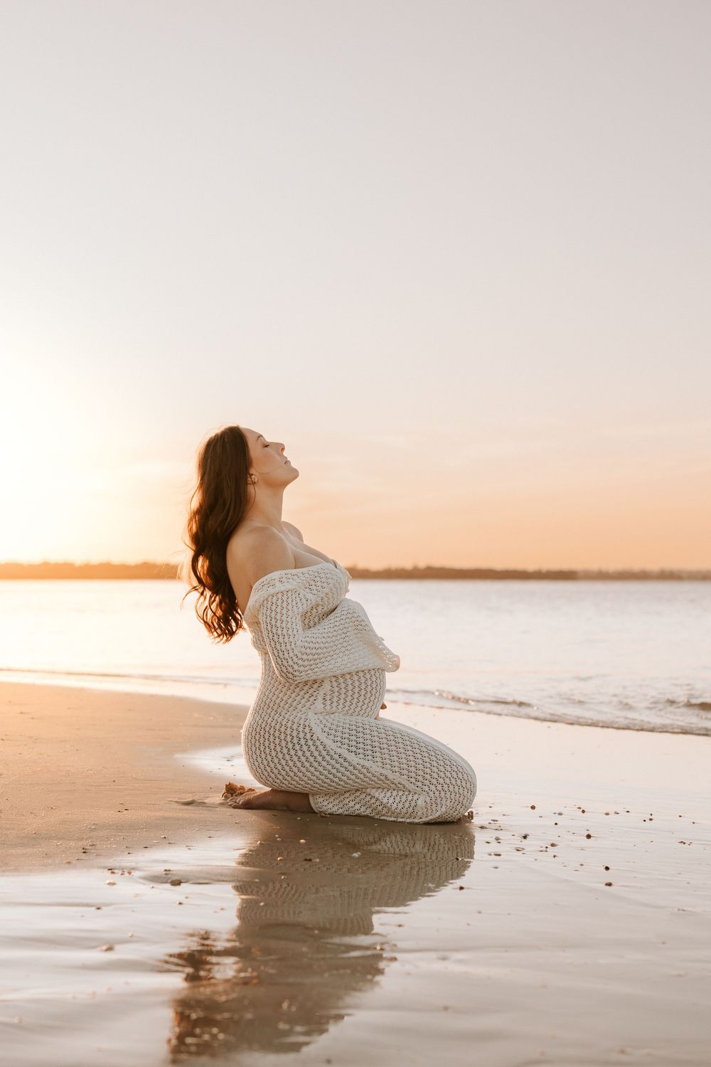 Pregnant Mum kneeling at sunset