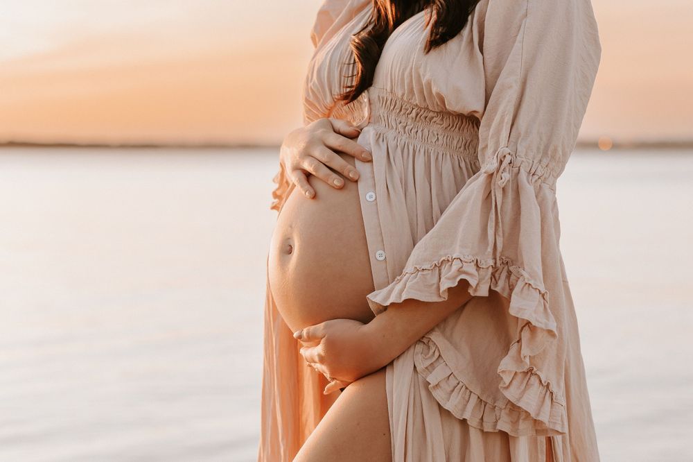 Pregnant belly at sunset