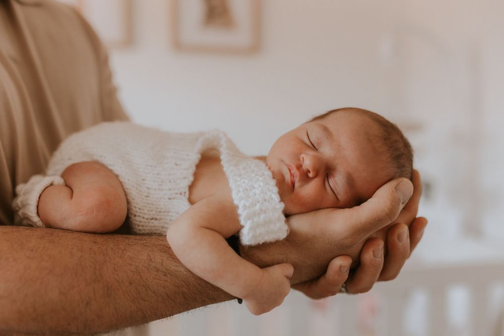Dad holding newborn in arms