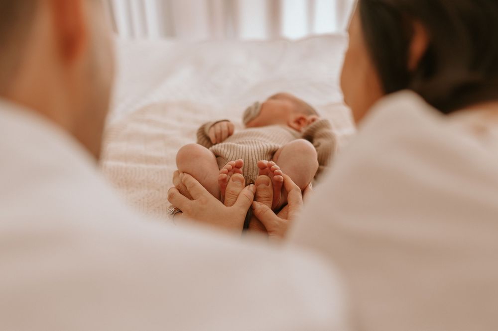 Mum and Dad holding newborn feet