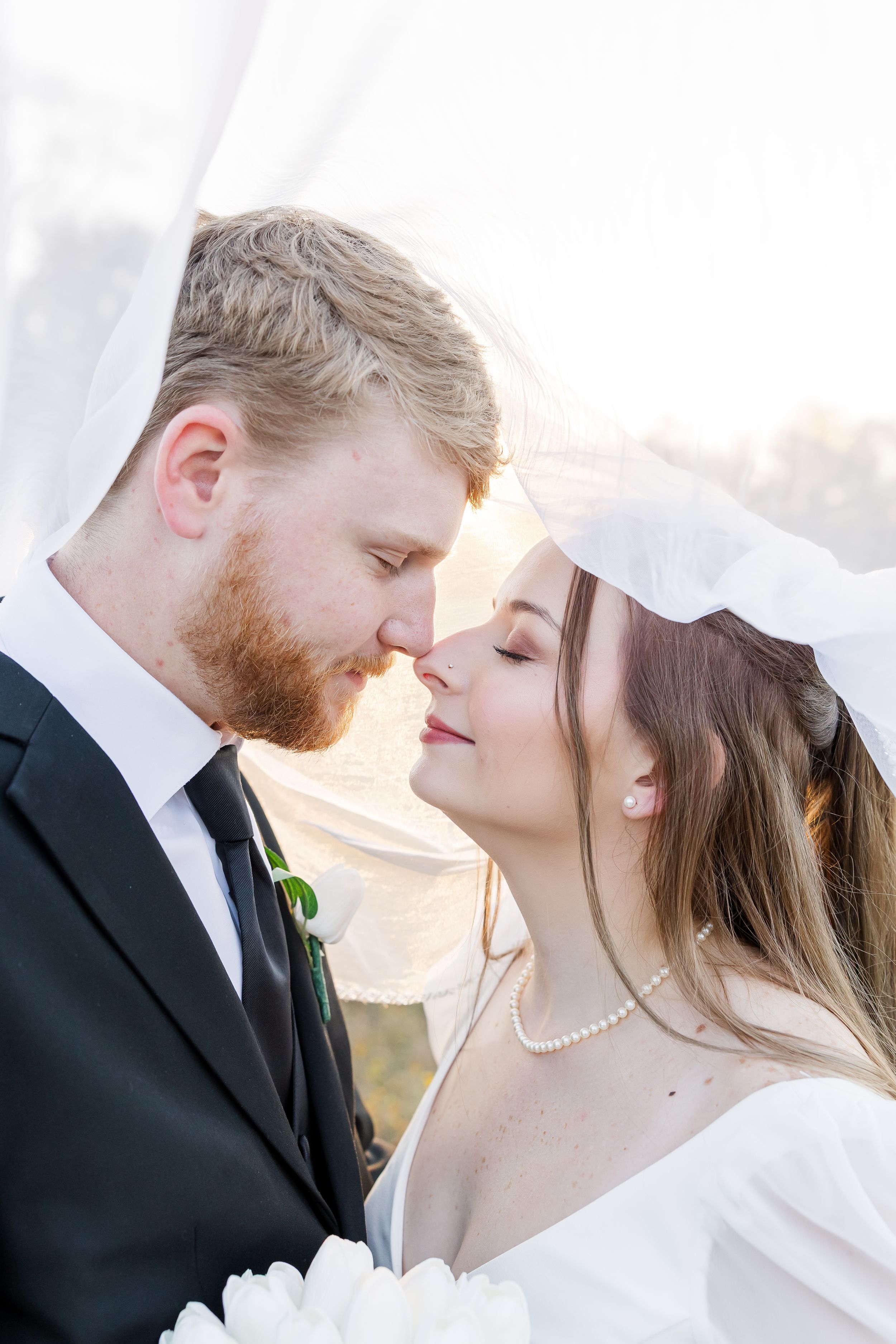 Romantic wedding portrait sequence showing a tender moment between newlyweds at sunset.