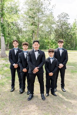 groomsmen and groom posing for their photos on the wedding day