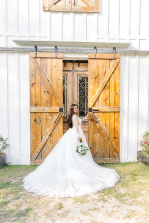 Bride standing in front of a beautiful door holding her bouquet