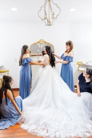 Bridemaids helping the bride to get ready for the weeding ceremony