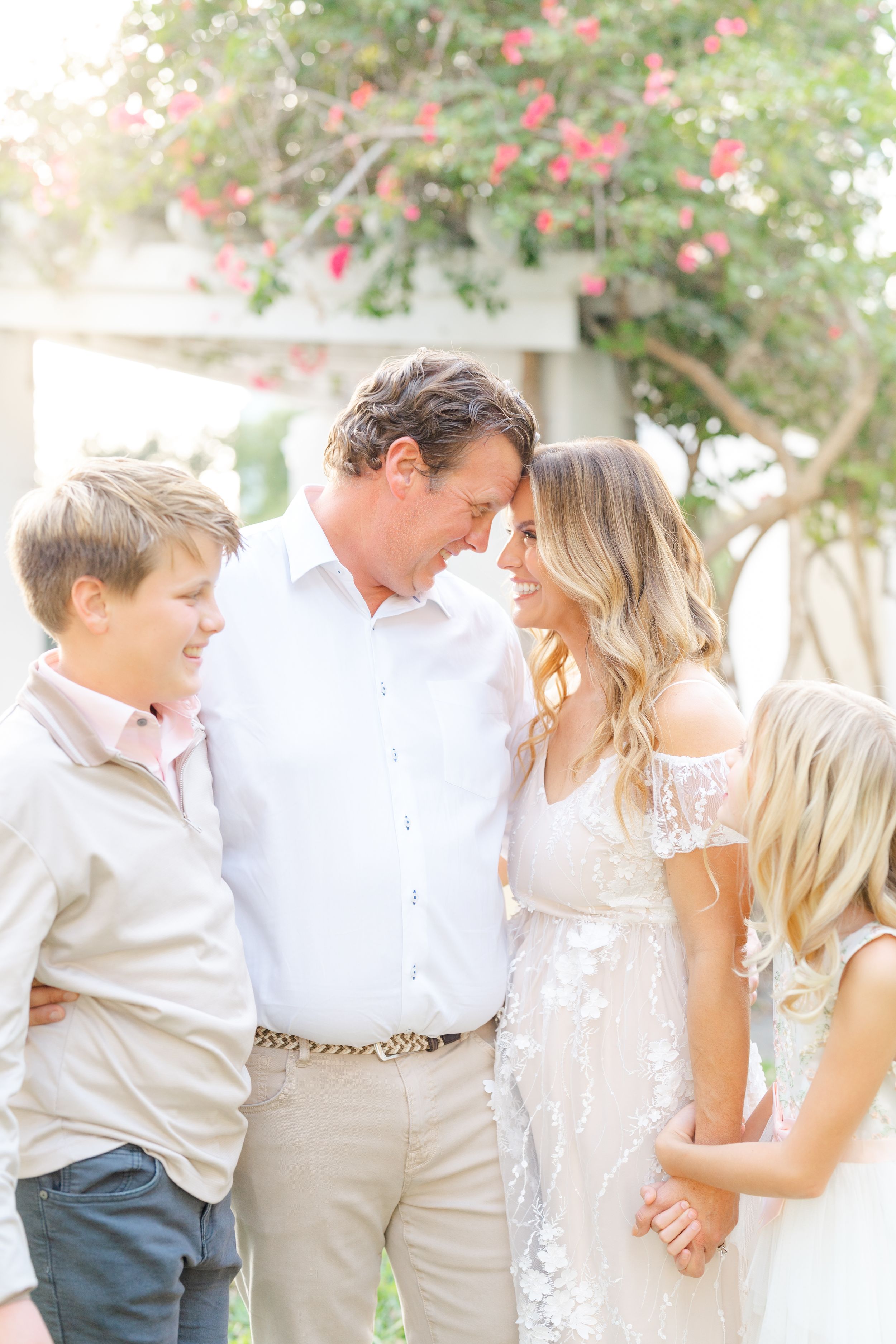 family holding hands smiling and looking at each other at The Vinoy in Downtown St. Pete during family photoshoot at golden hour