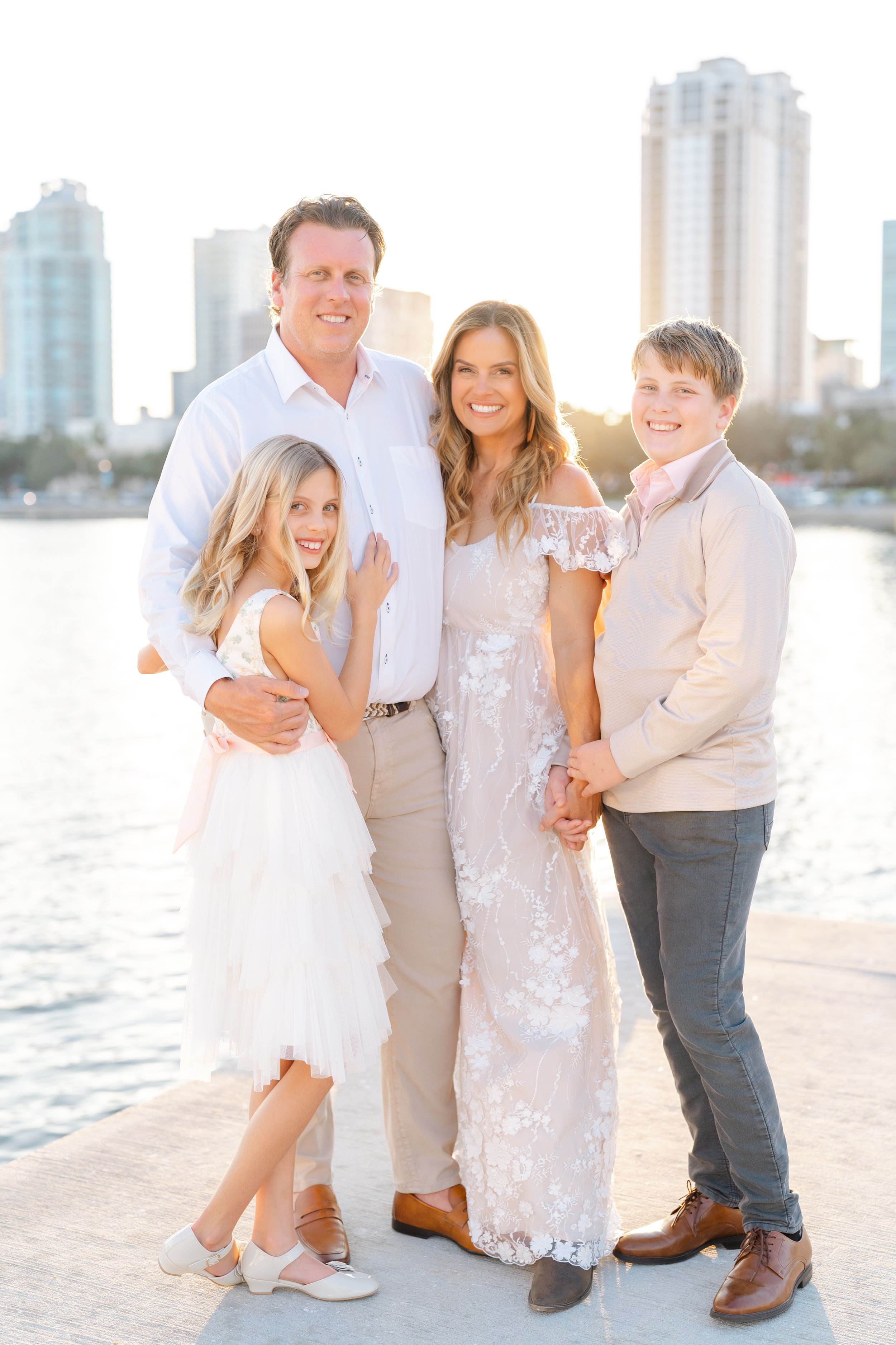 family cuddled up on the docks at The Vinoy overlooking downtown St. Petersburg the water during their family photoshoot