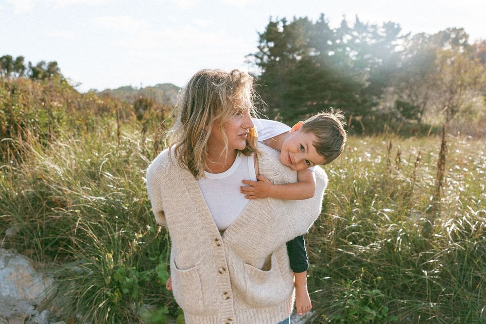 Sun-drenched portraits in a golden field during a playful outdoor photo session.