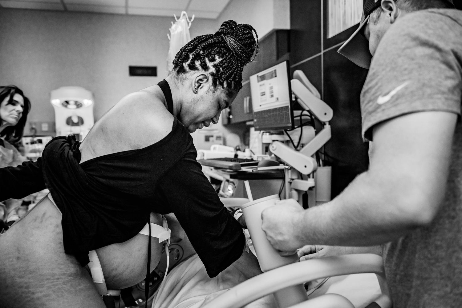A birthing scene shows support team members assisting during active labor.