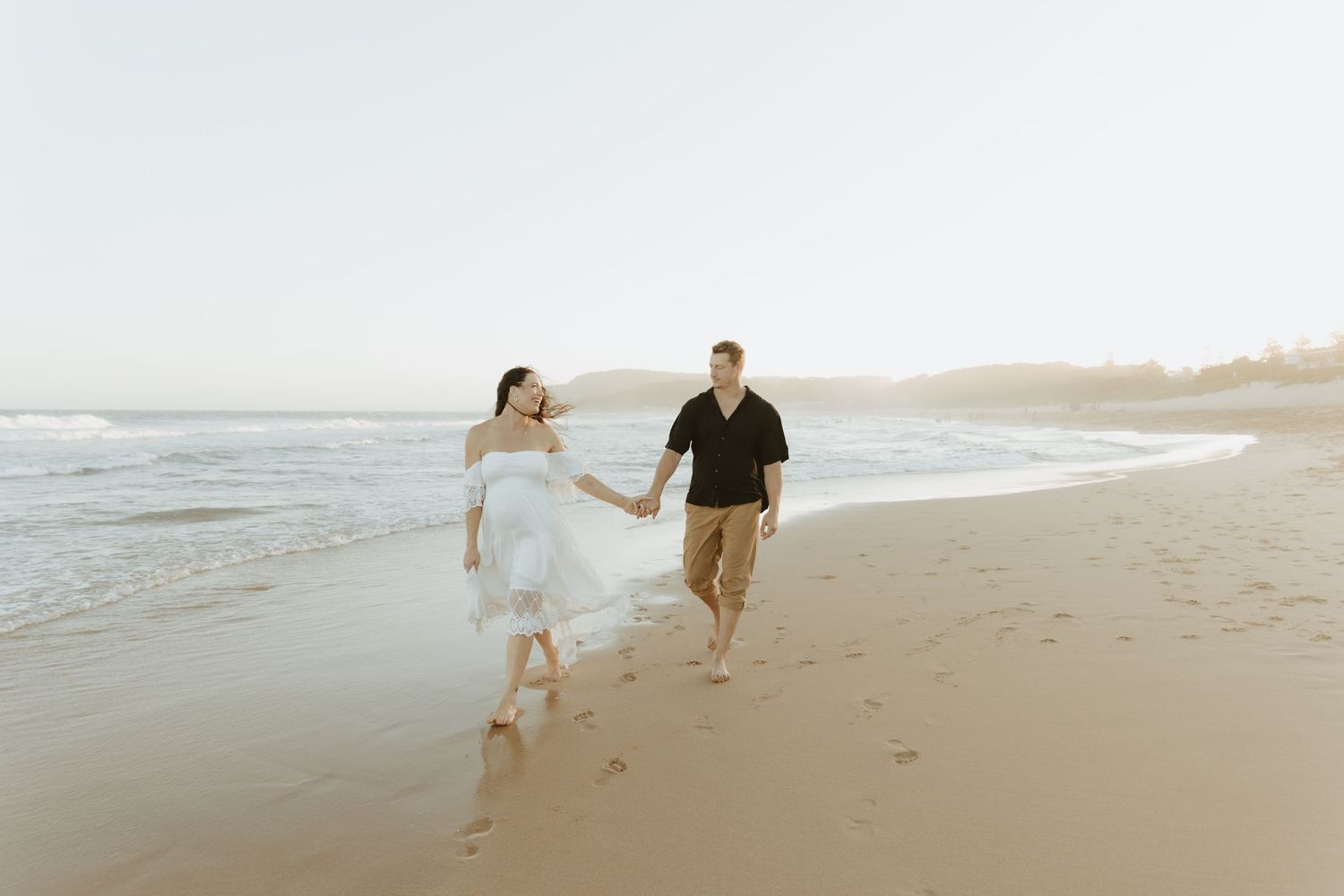 Couples maternity photos taken on the beach at sunset in Lake Macquarie NSW. Natural candid style photos capturing connection.