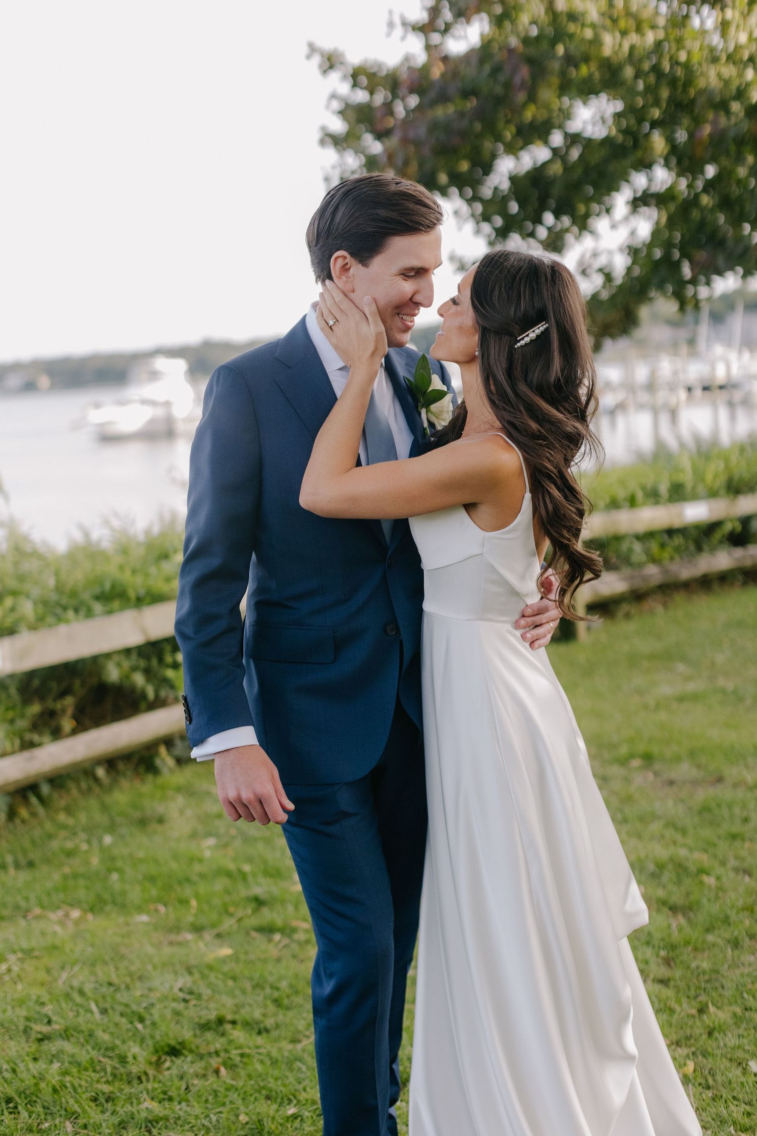 A romantic dance dip during a wedding reception under a clear tent with string lights.