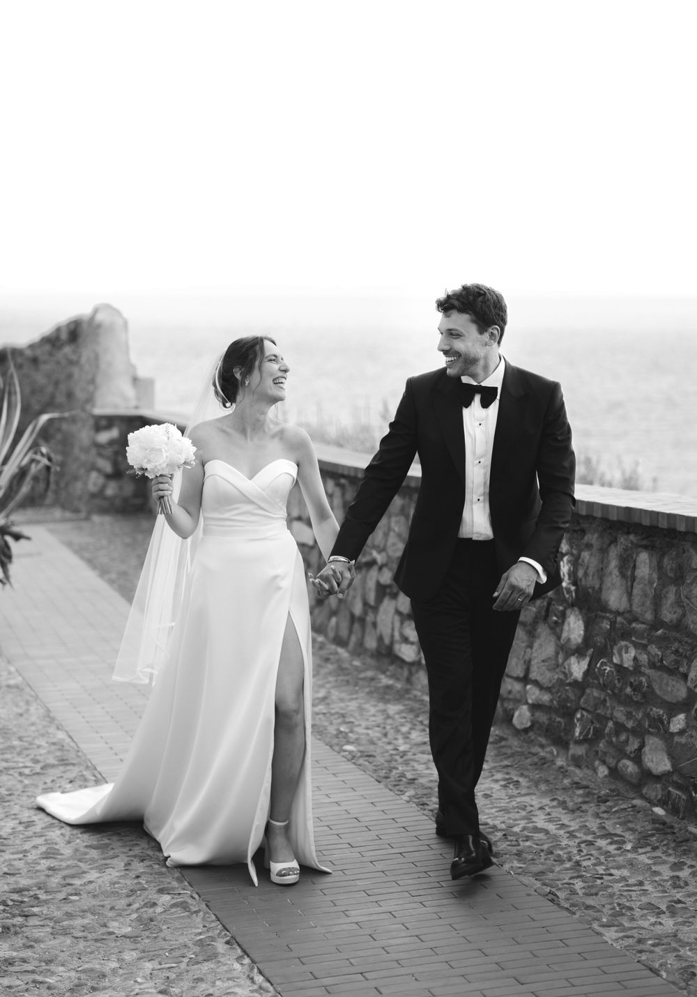 the newlyweds walk through the village of Cervo in Liguria