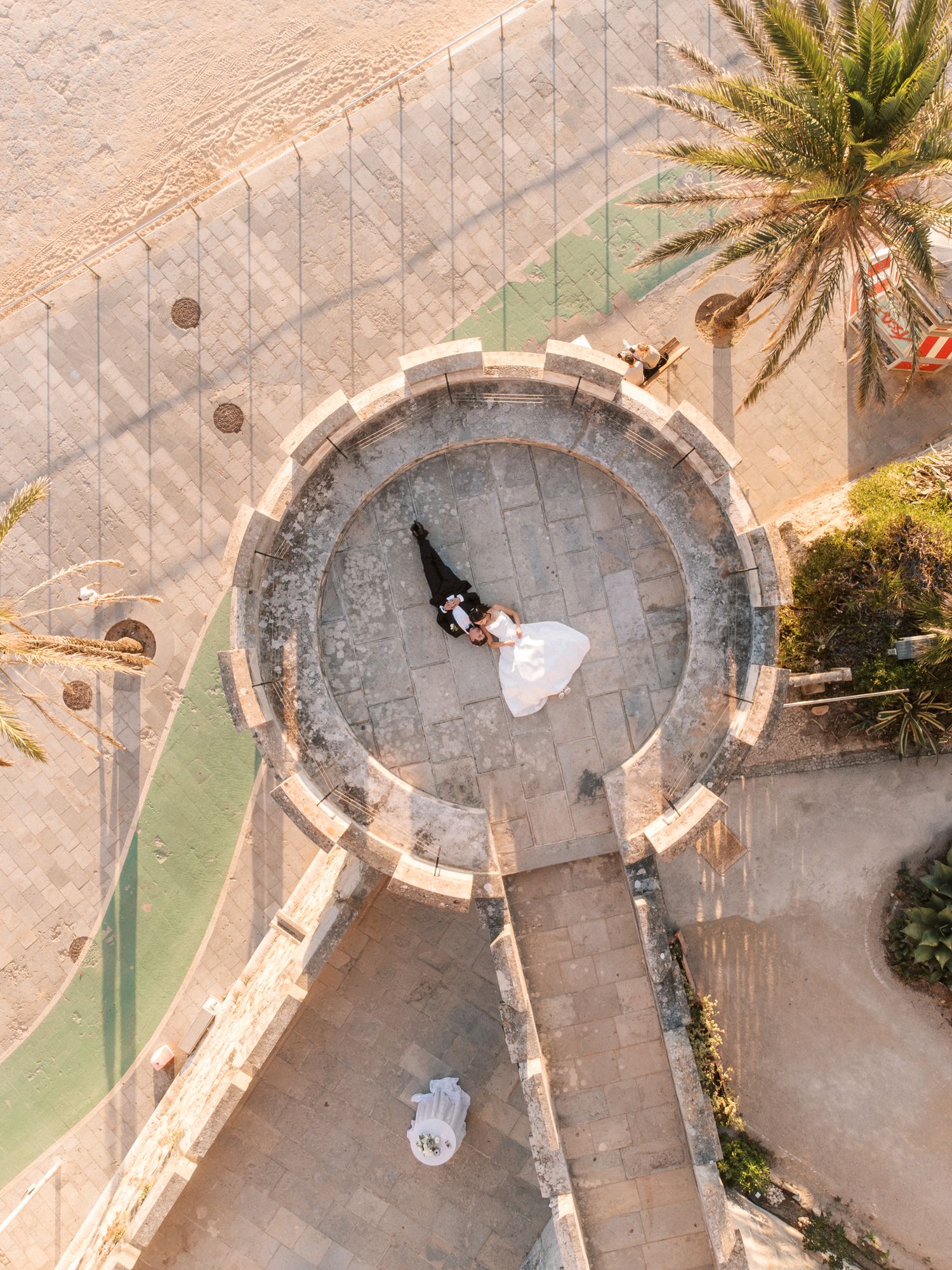 Aerial view of bride and groom by the sea at Forte da Cruz in Cascais Portugal