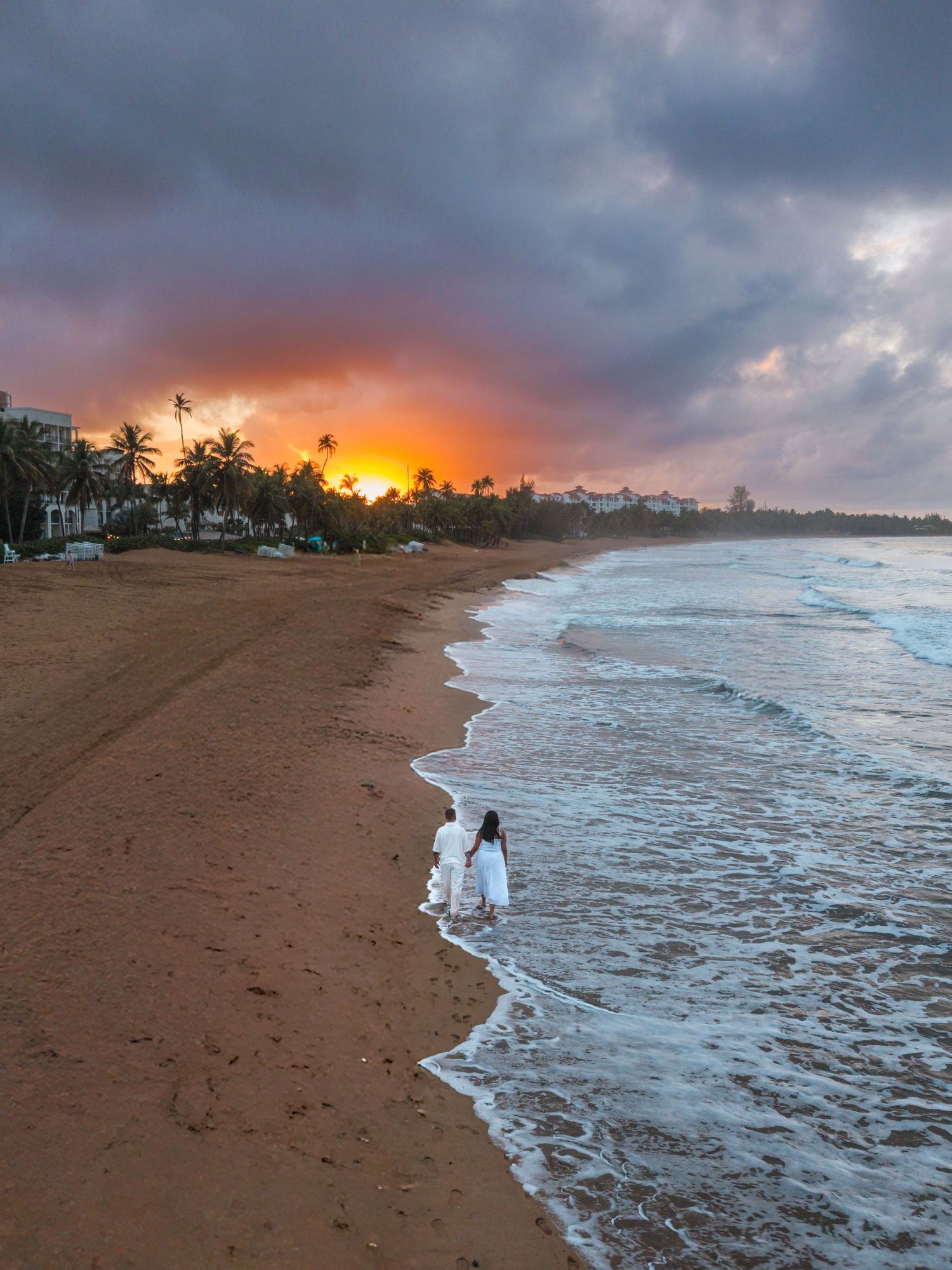 Dramatic beach scene with waves and glowing sunset sky creating a cinematic coastal atmosphere