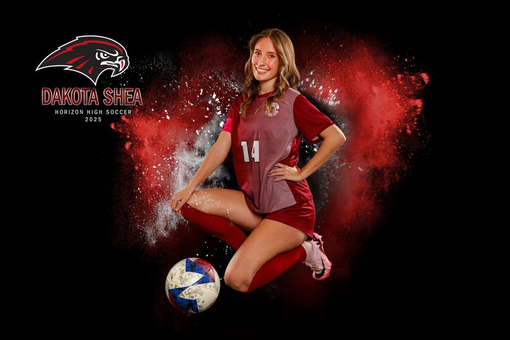 Athletic portrait with player kneeling with soccer ball on dark background with red effects.