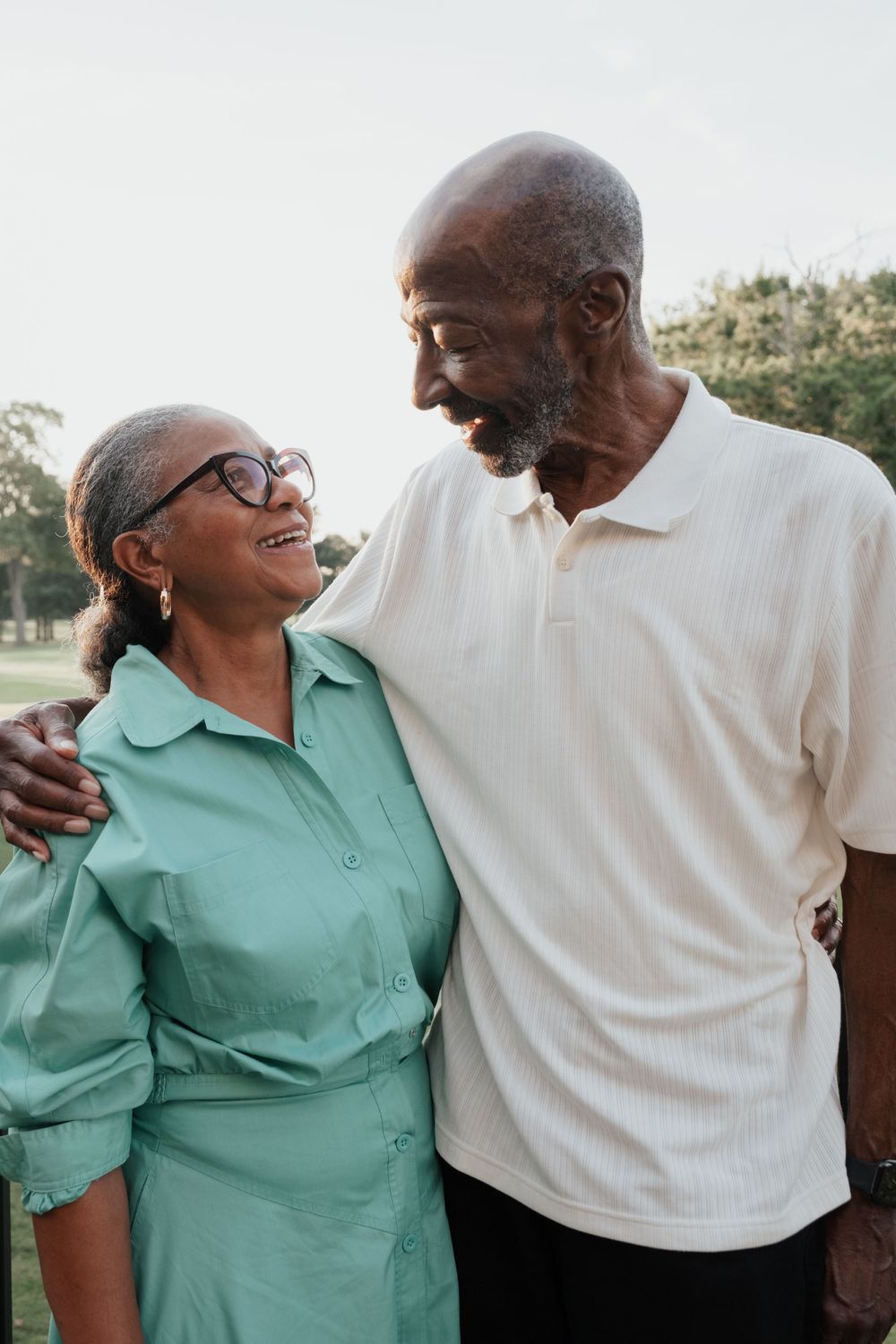 Loving senior couple enjoying a happy moment together outdoors, sharing laughter and embraces.