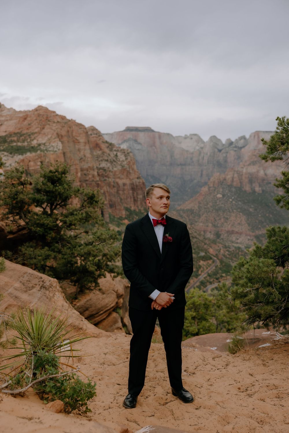 A formal portrait session at sunset in Zion National Park featuring dramatic red rock cliffs and desert landscape.