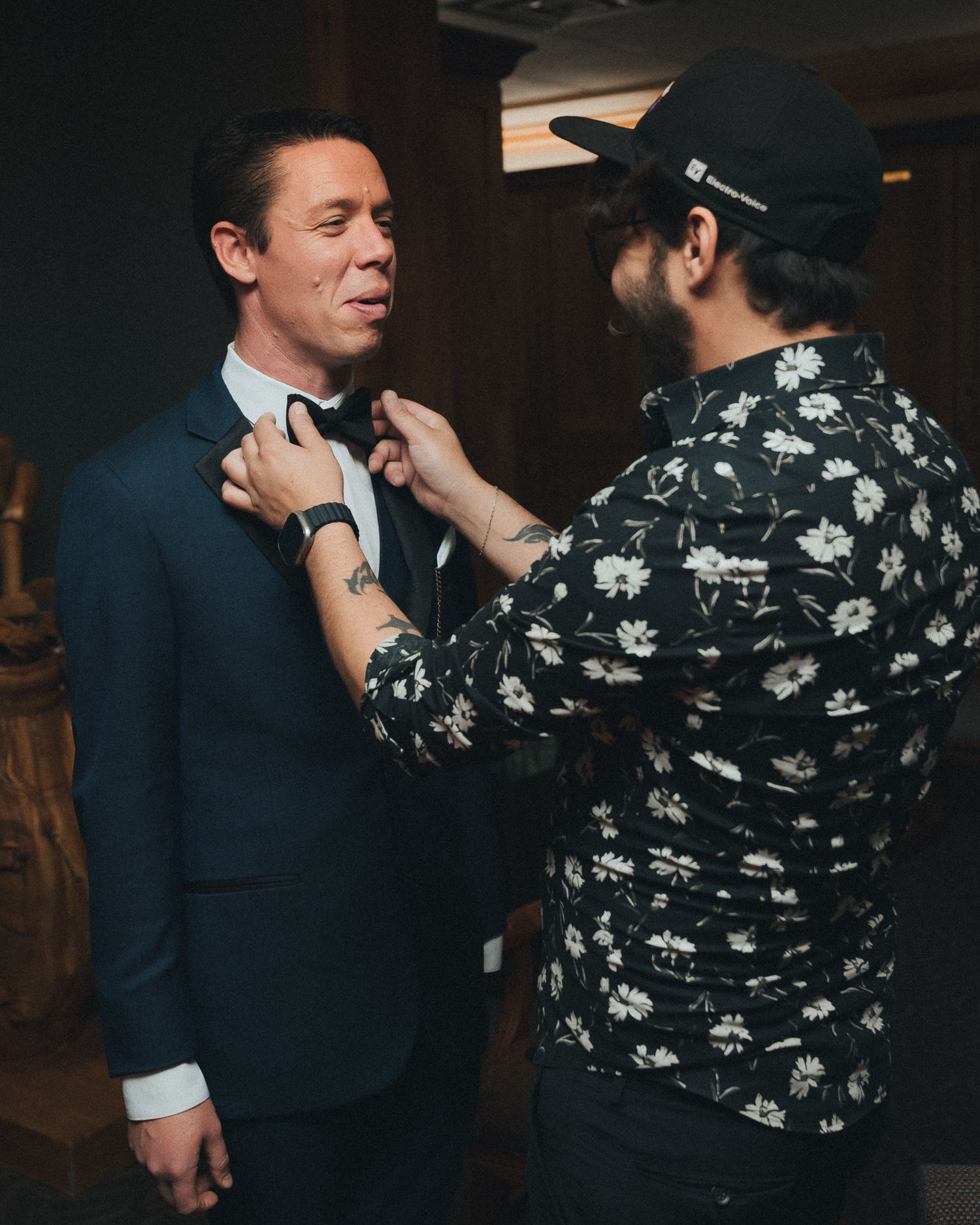 Coordinator helps groomsman with tie and other details just prior to the ceremony.