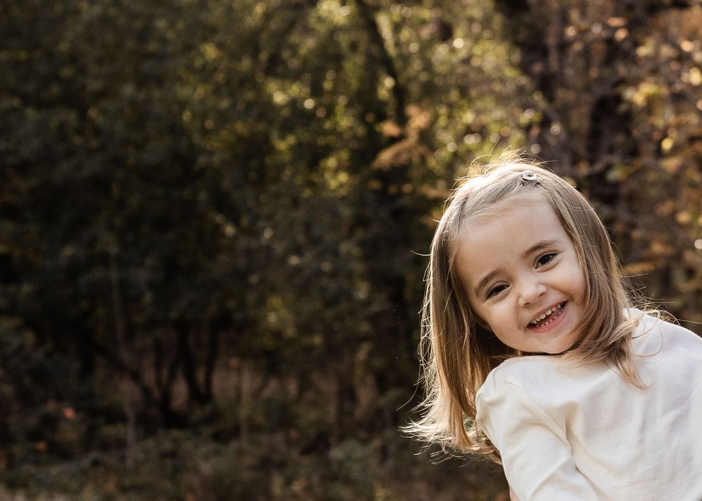 A series of connected outdoor portrait photographs showing joyful expressions and natural lighting in a wooded setting.
