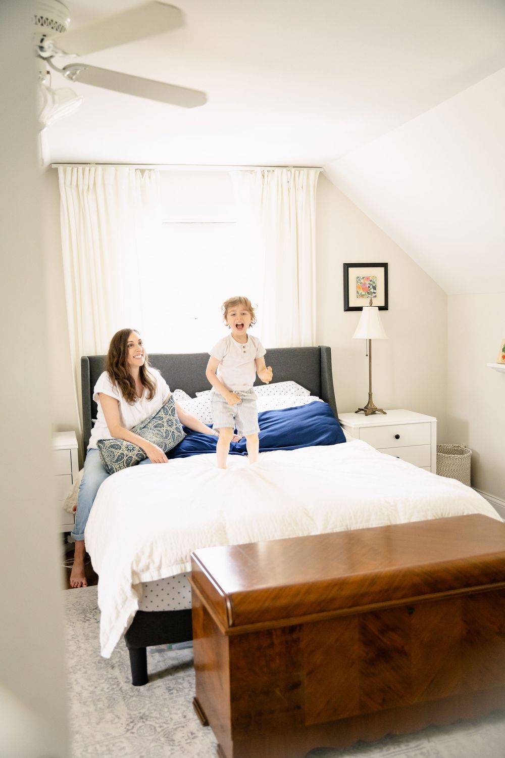 A sequence of photos showing a family relaxing together on a modern wooden bed frame with white bedding.